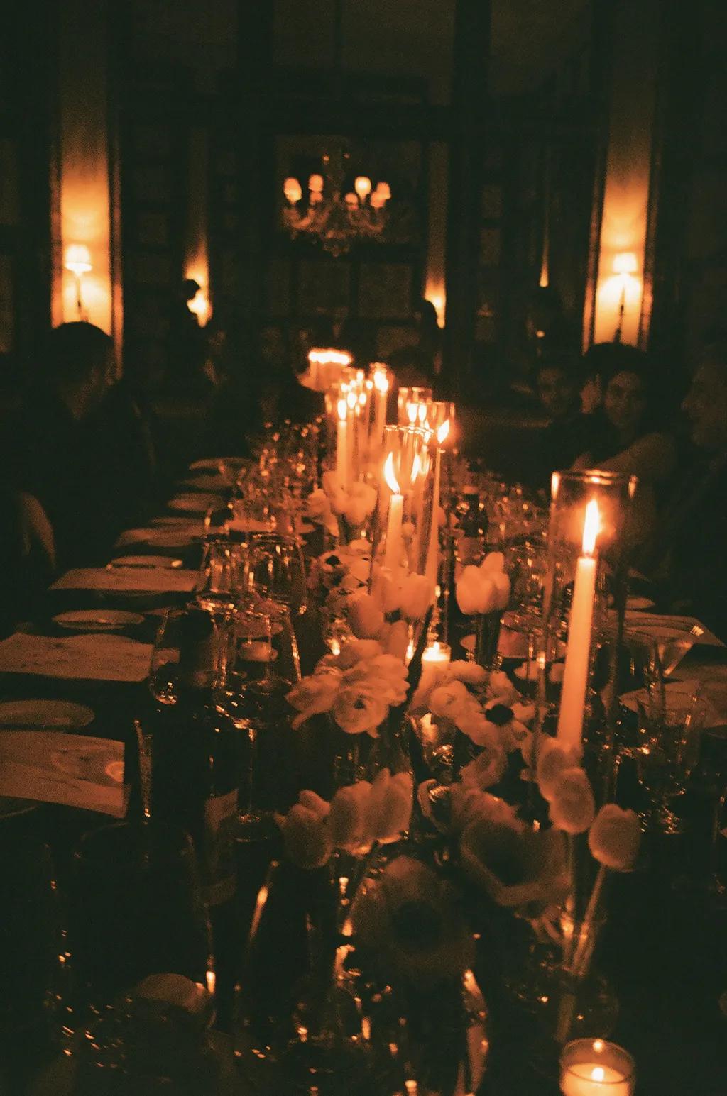 Elegant long table inside Dowlings adorned with luxury glassware and simplistic floral settings. 