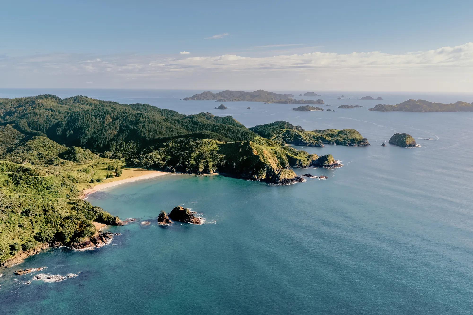 Aerial shot of the Kauri Cliffs Golf Course, Waiaua Bay and looking out to the Cavalli Islands.