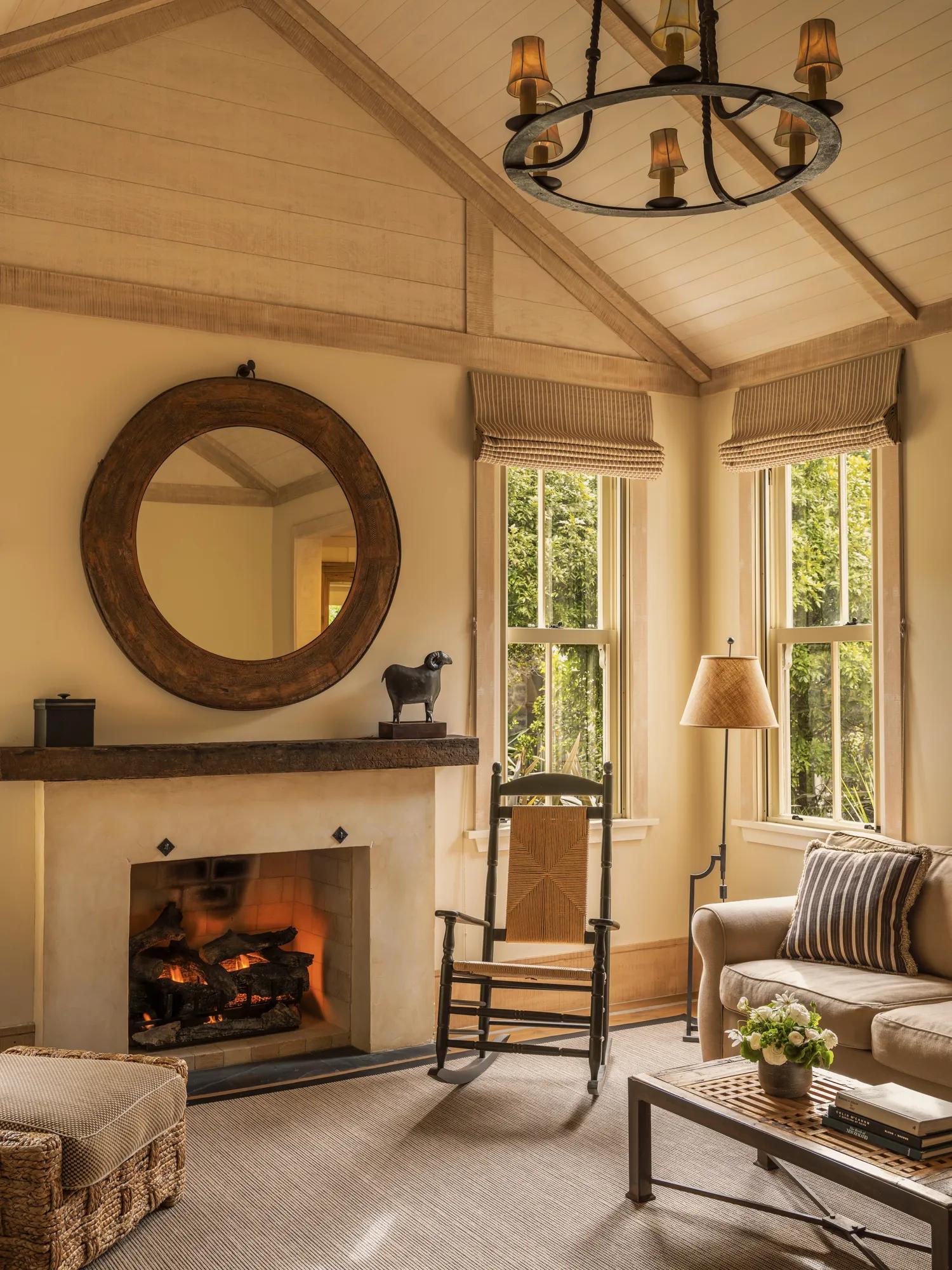 Study and sitting room in a luxury villa with fireplace and refined countryside interiors.