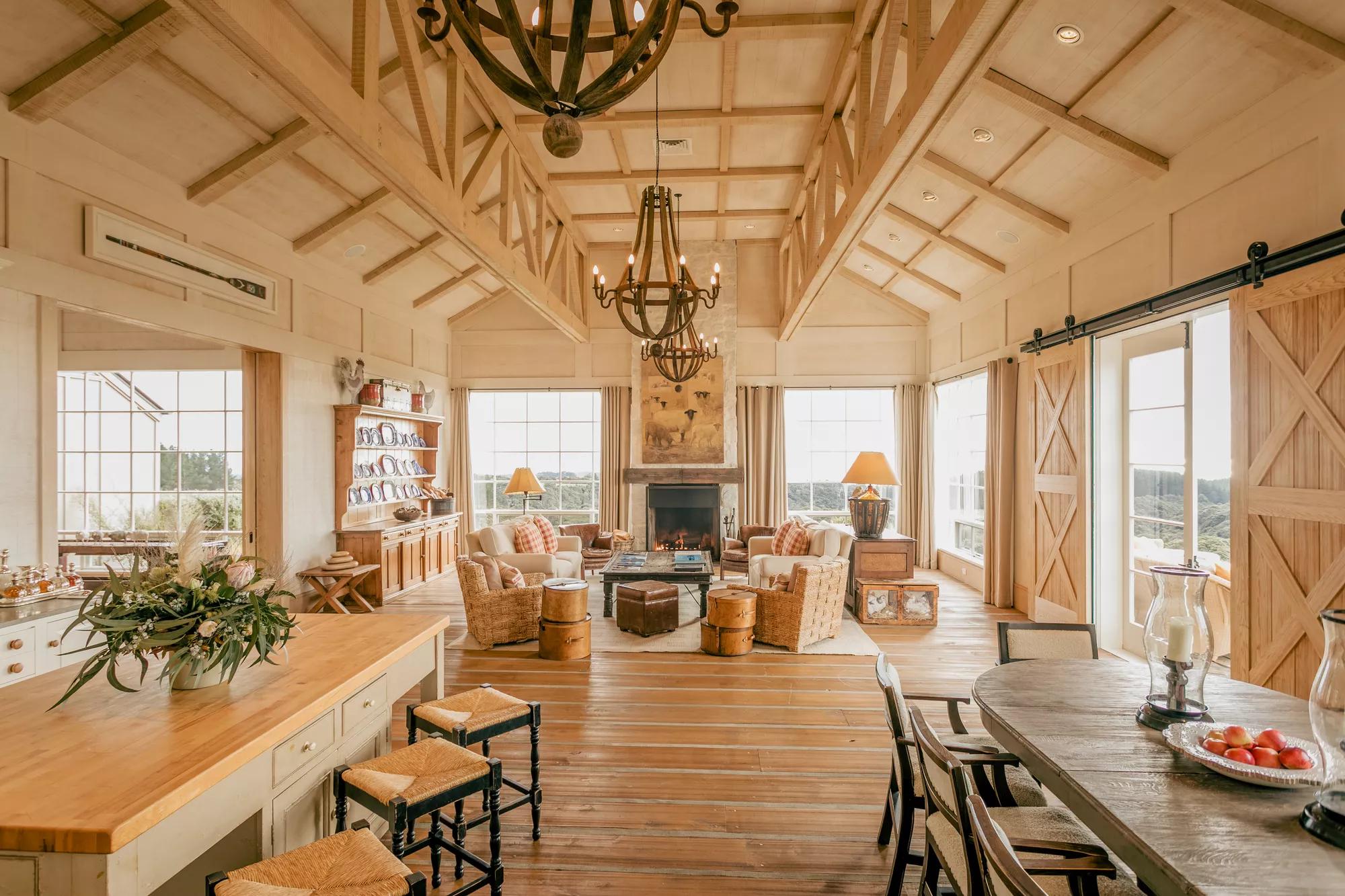 Spacious living area in the luxury four bedroom villa at Rosewood Cape Kidnappers with high ceilings, open fire and refined countryside interiors.