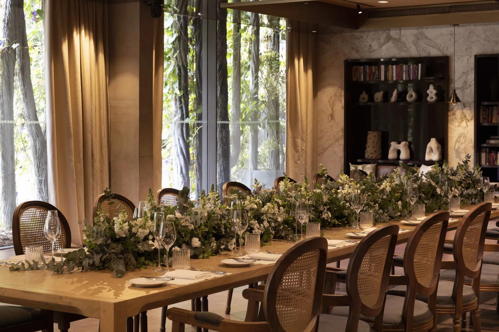 Pavilion with flower- decorated table and natural light.