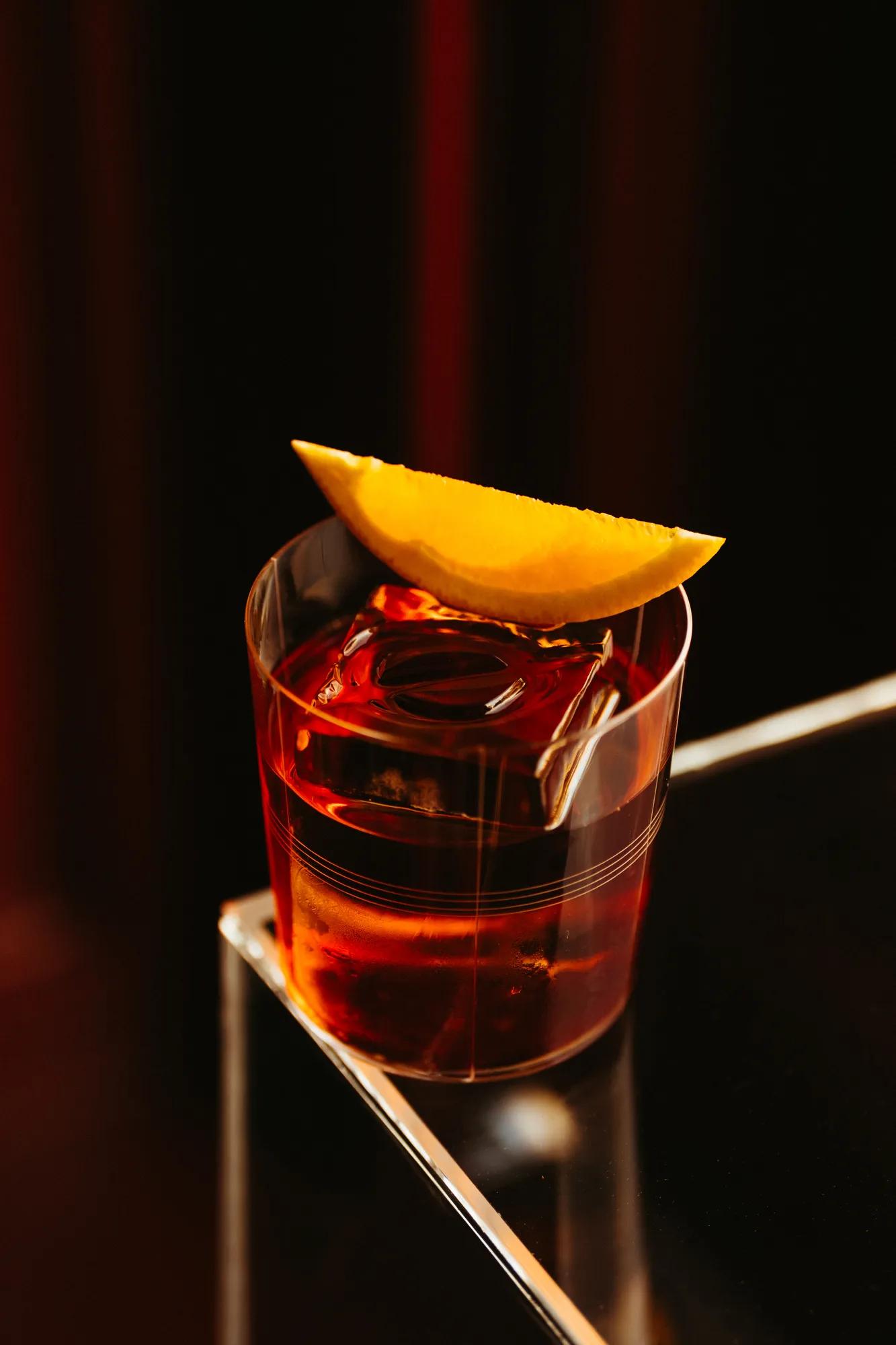 red coloured cocktail on table corner