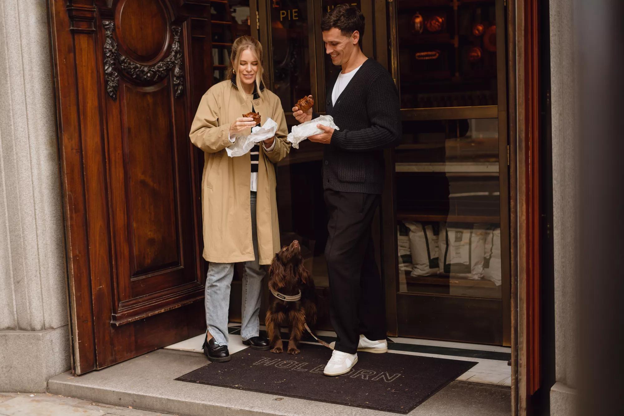Two guests enjoying takeaway pies at the pie hole in Rosewood London