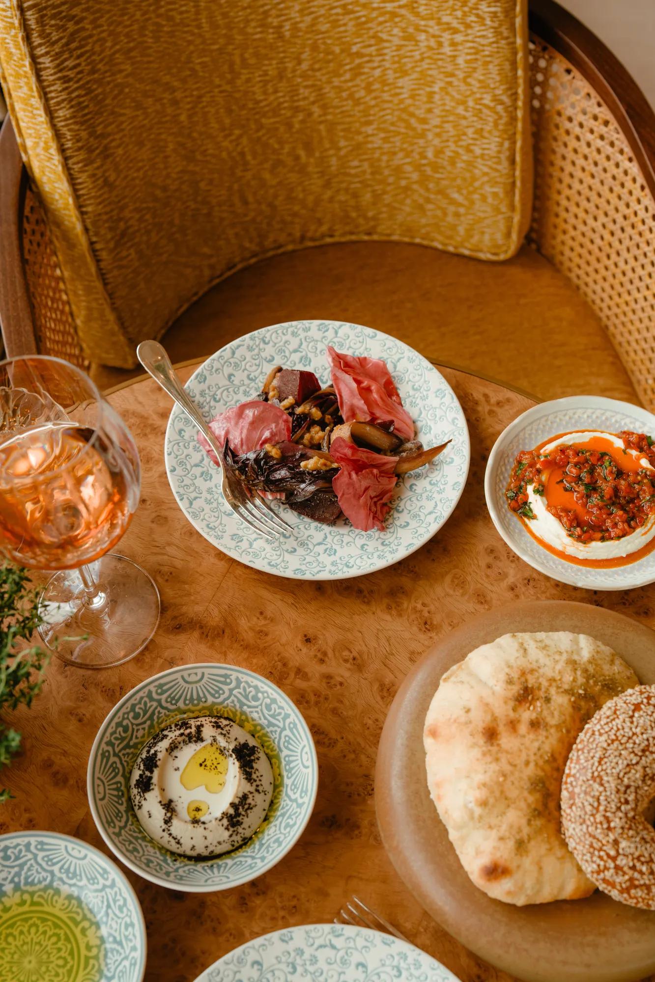 mediterrean sharing dishes on the table at serra at the chancery rosewood