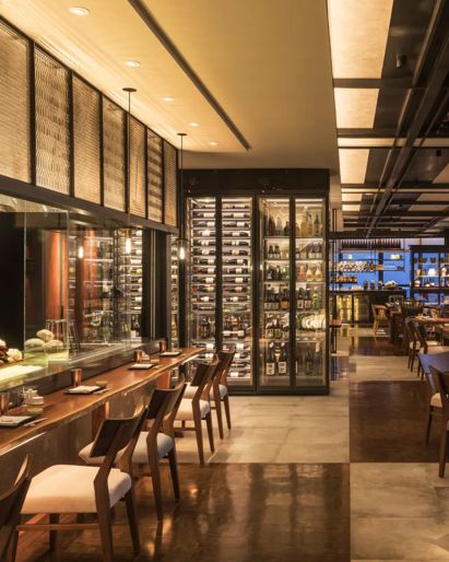 Hotel restaurant in Phnom  Penh with wooden tables and  wine cellar. 