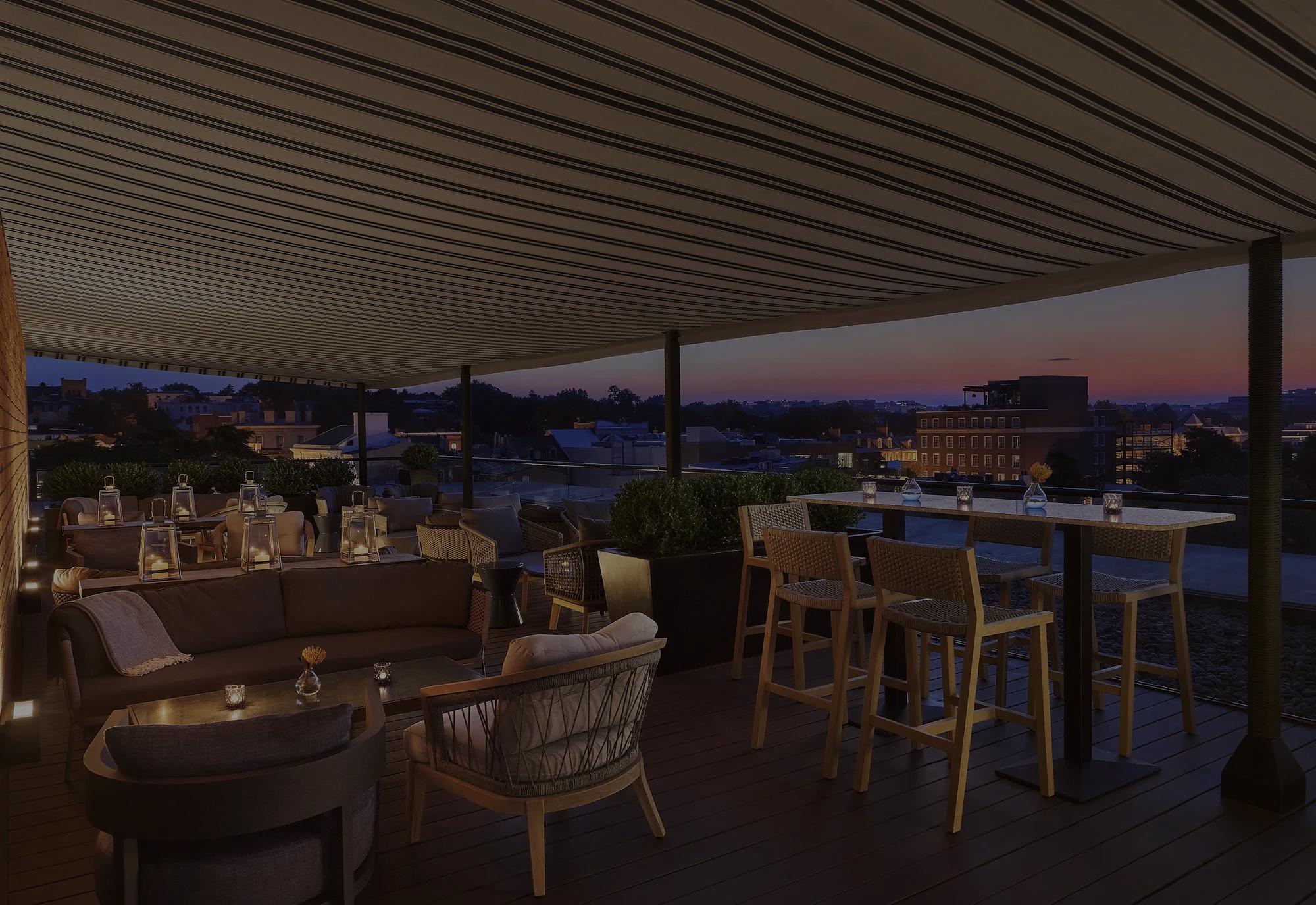 Rooftop with 360-degree views in the heart of Georgetown with modern furniture and a sunset in the background
