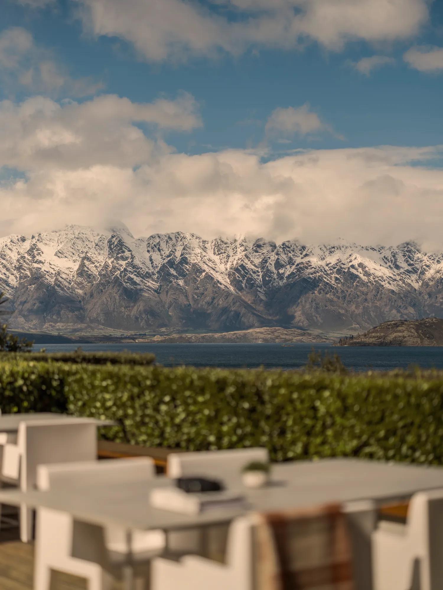 Overlooking the outdoor dining set up on the Remarkables Terrace with views of Lake Wakatipu and snow covered Remarkables Mountain Range. 