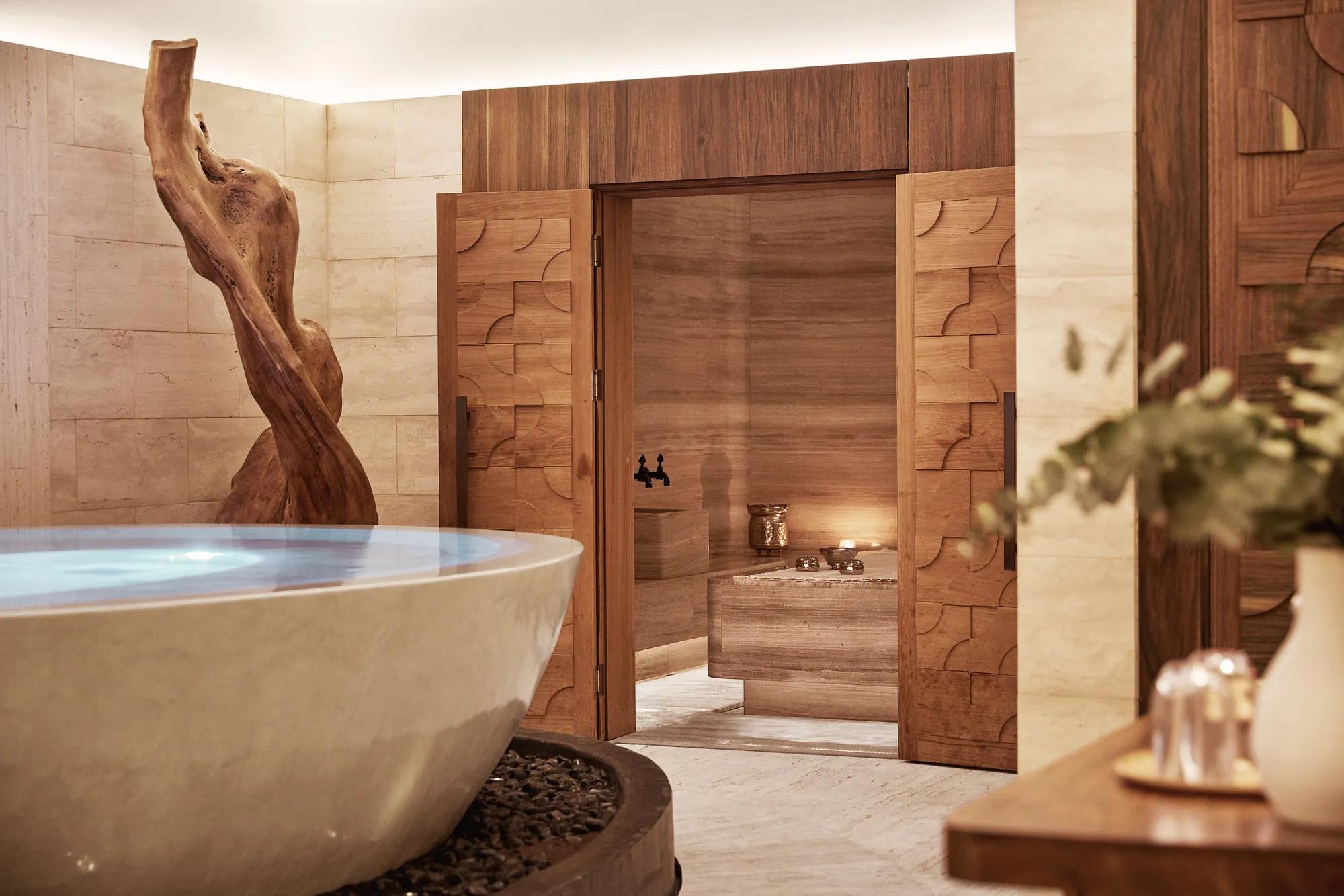 Sophisticated spa in Madrid featuring a wooden sculpture and a relaxation area.