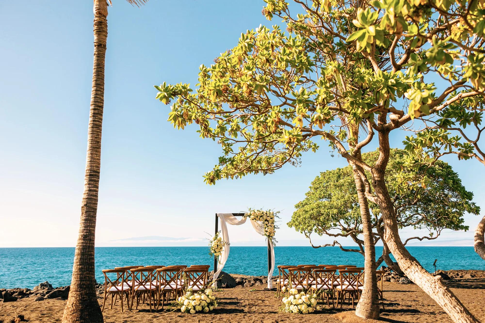 Wedding alter and chairs set for a wedding ceremony on the sand with the ocean in the background
