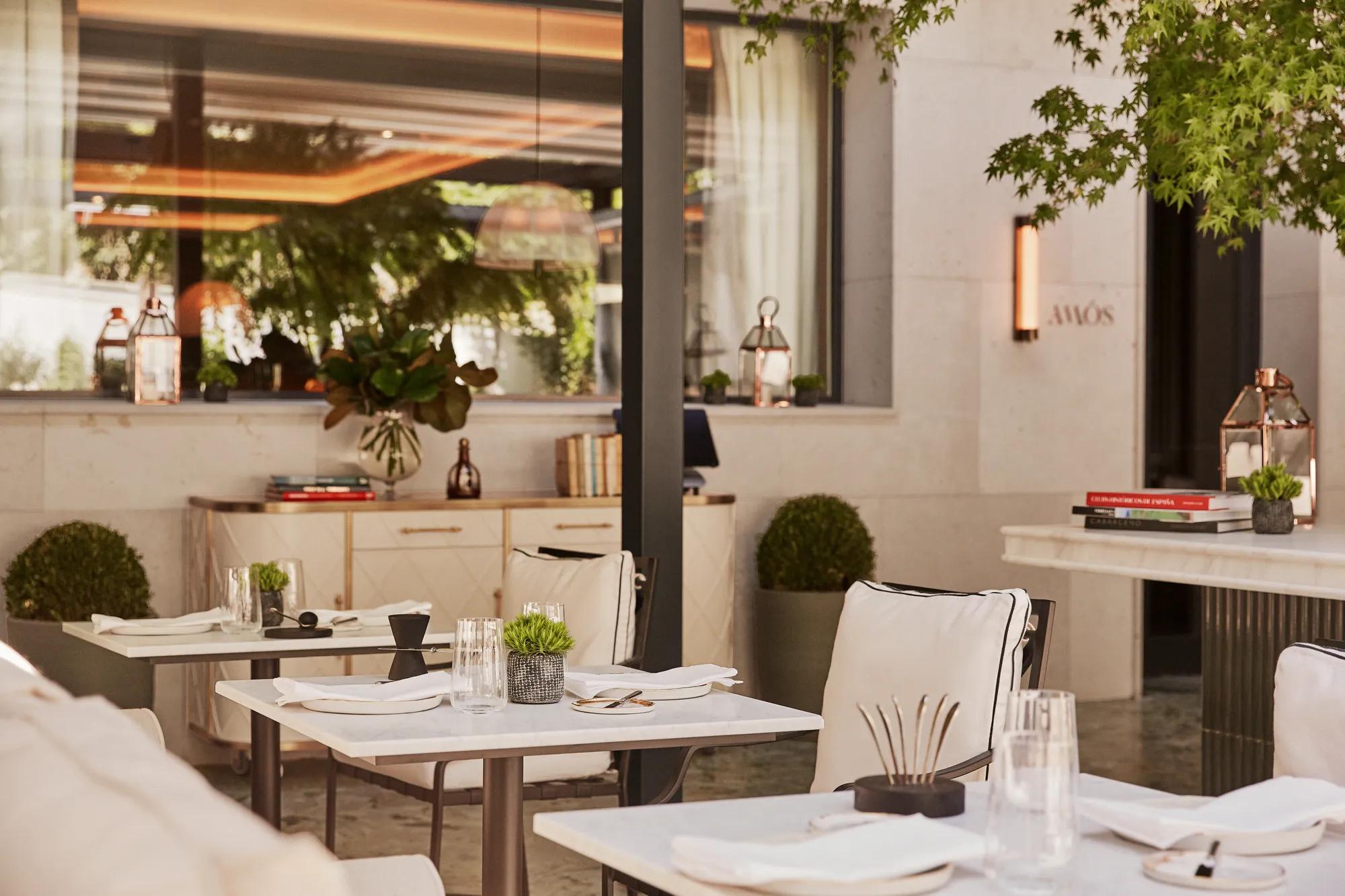 Elegant restaurant bar featuring high green tables, set in a sophisticated space designed for a tapas experience for two