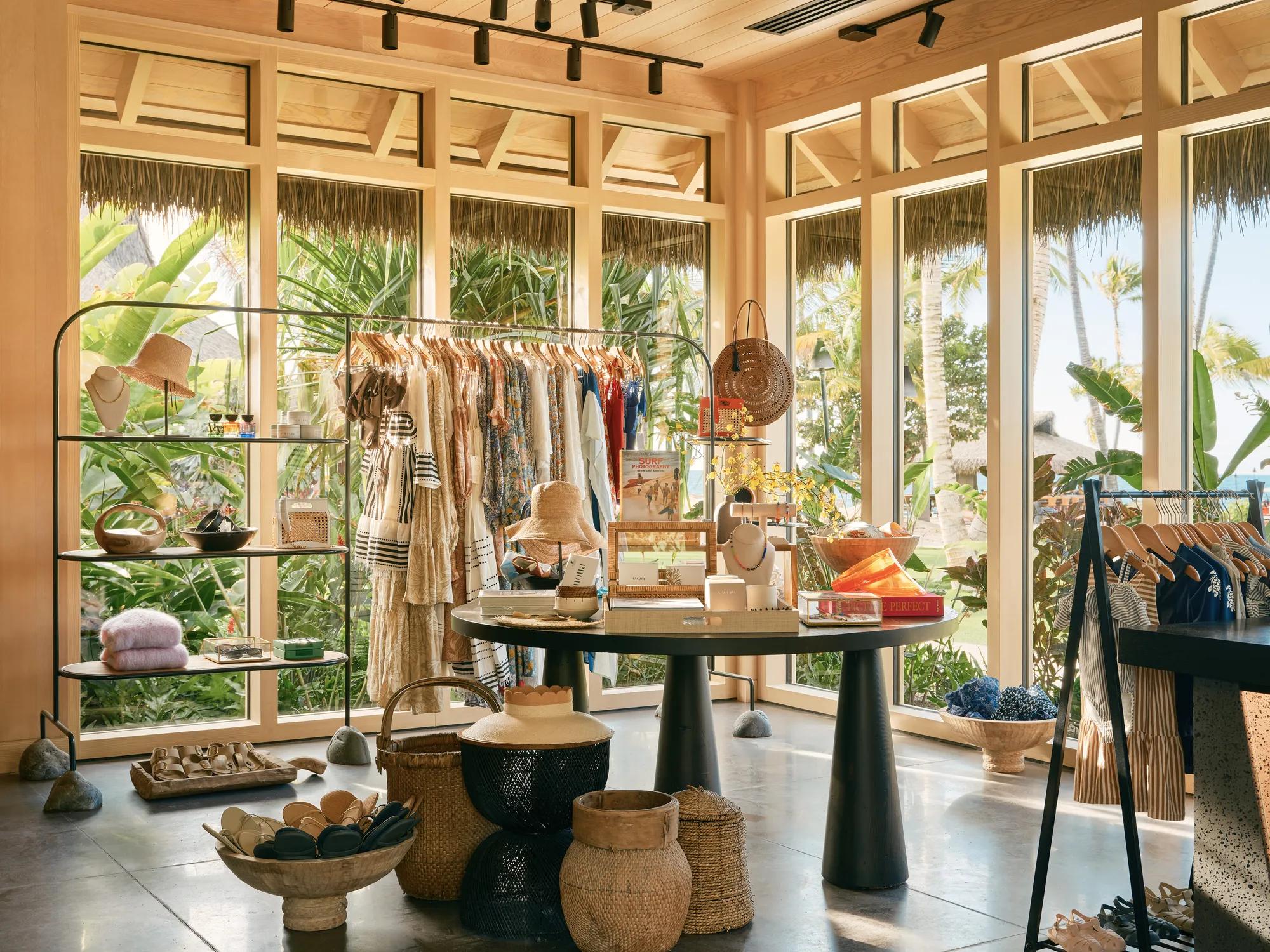 Interior of a boutique with windows and natural light surrounded by vegetation