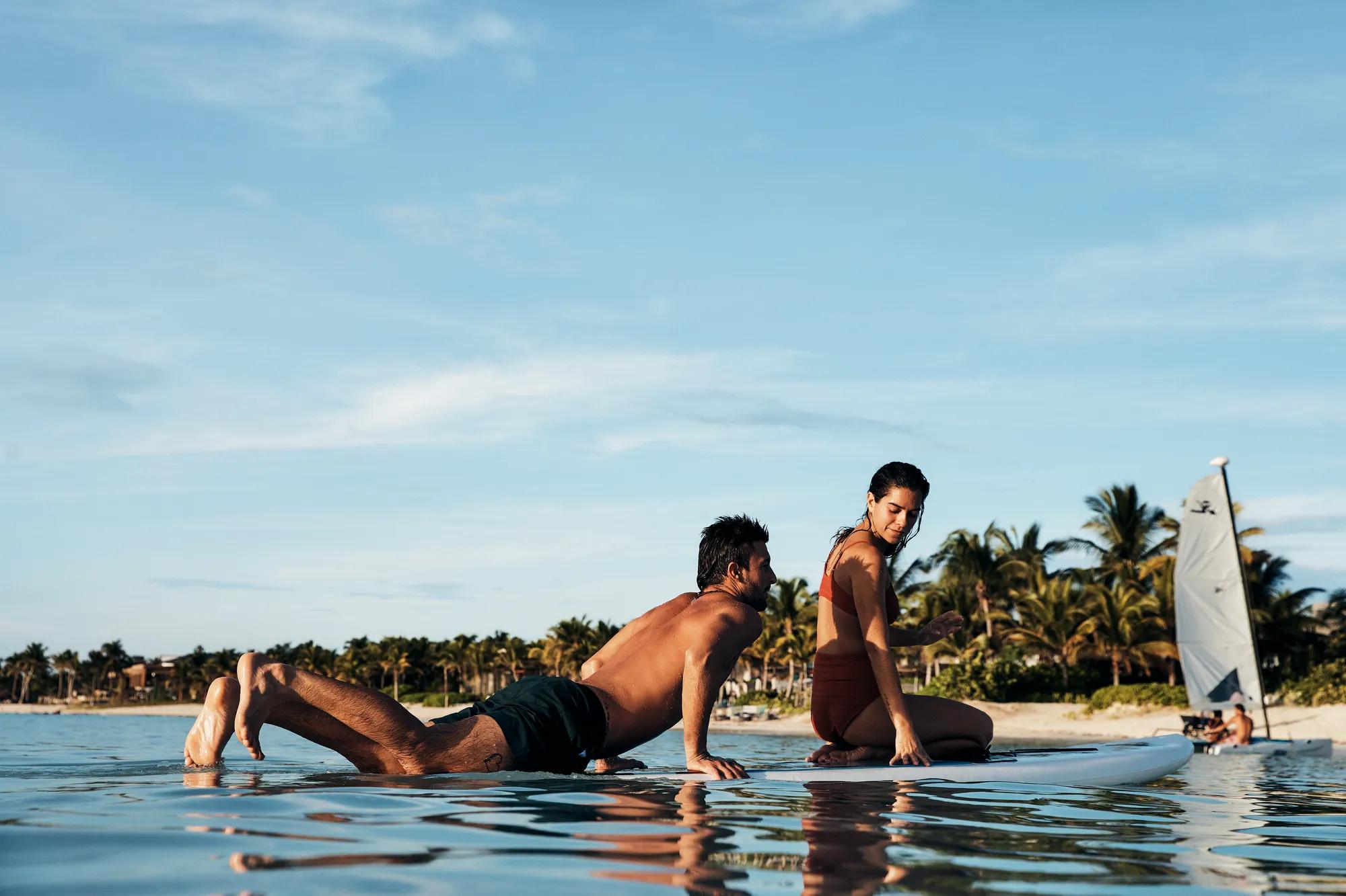 Rosewood Mayakoba - Guests paddleboarding along the resort's private beach