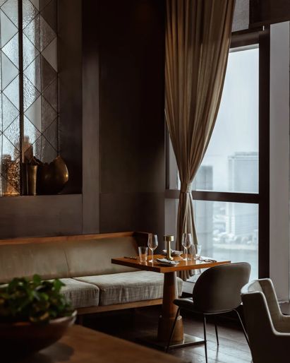 Hotel restaurant in Phnom  Penh with floor-to-ceiling  windows overlooking the  water. 
