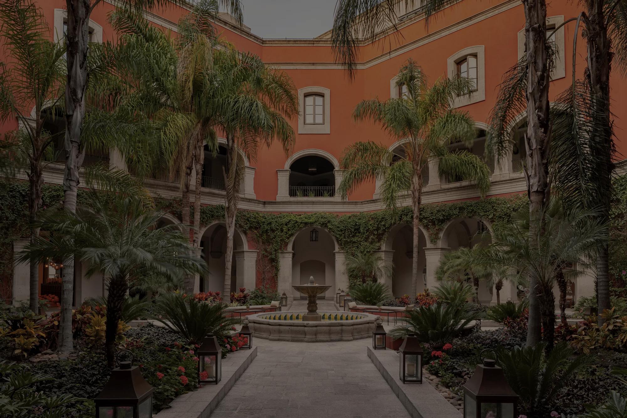 Colonial-style courtyard with lush gardens and central fountain at Rosewood San Miguel de Allende