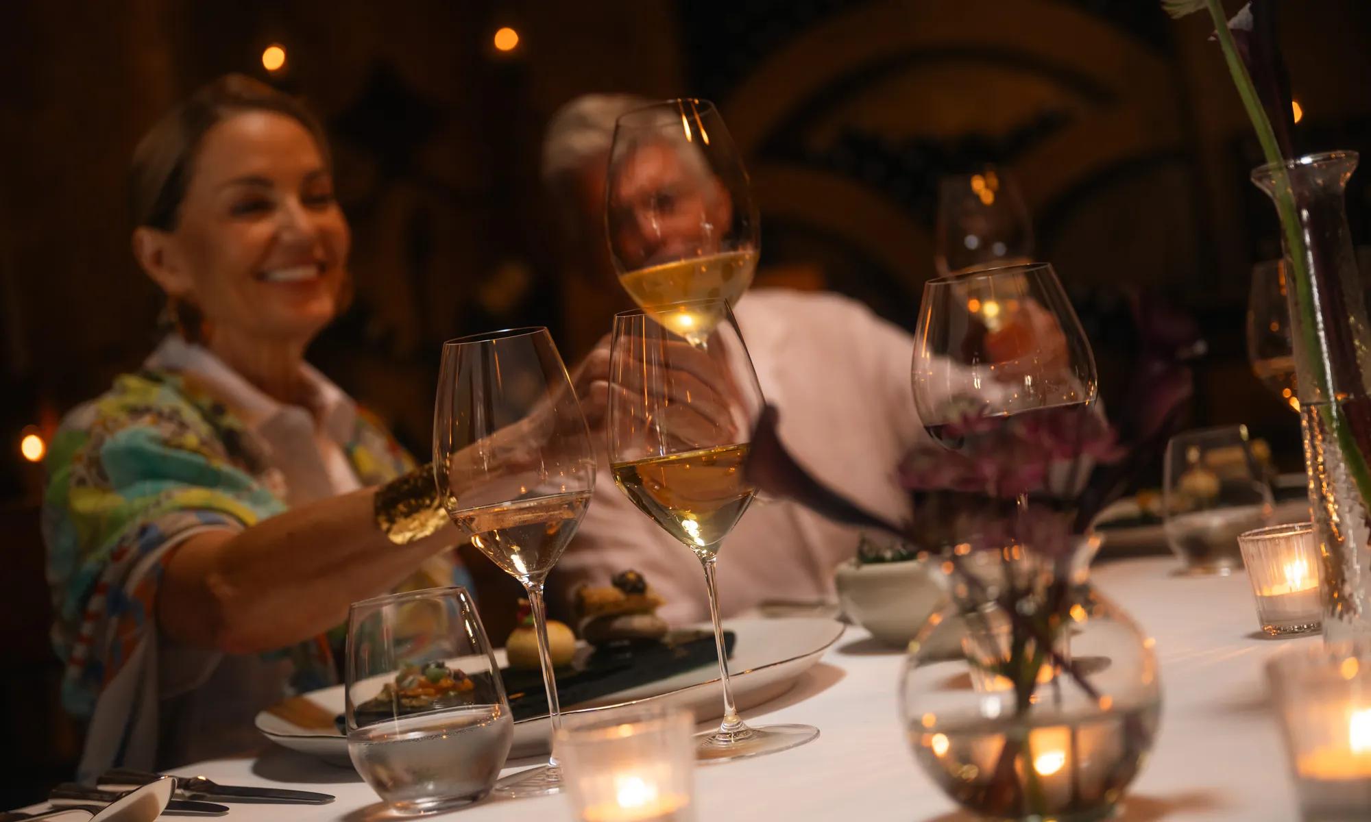 Private dining setup inside a wine cellar, surrounded by shelves of fine wines, creating an intimate and elegant atmosphere