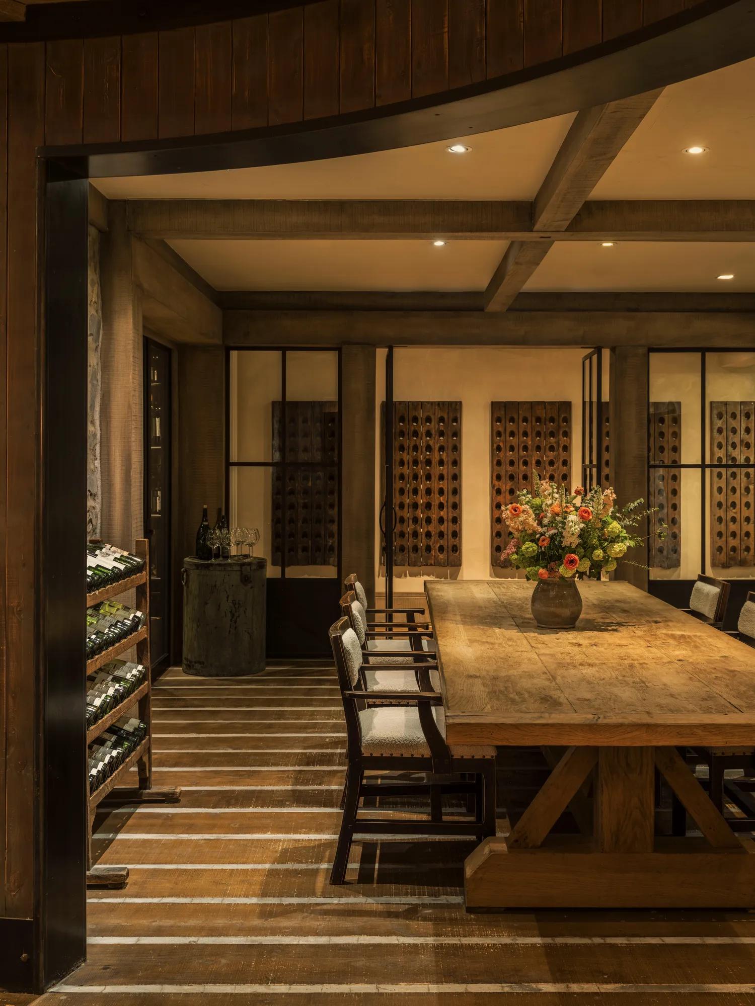 Private dining table in an underground wine cellar with stone and timber features