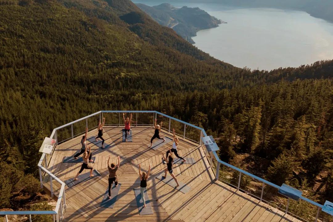 People doing Yoga with a beautiful mountain view