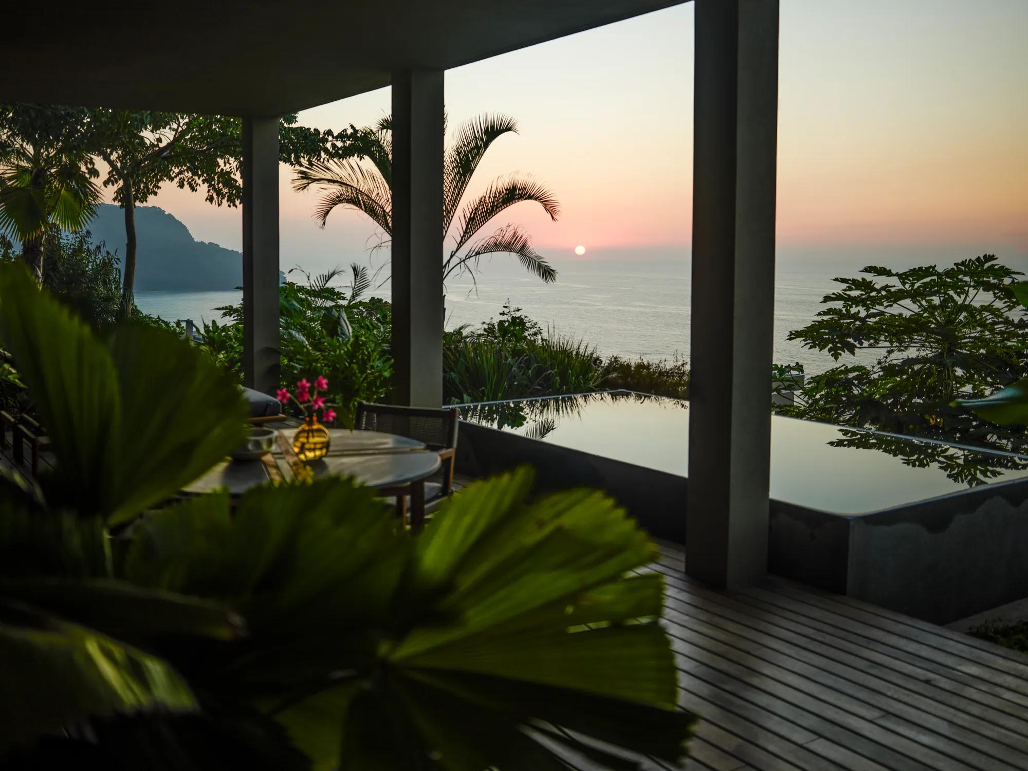 Sunset view from a tropical terrace with a plunge pool and ocean in the background