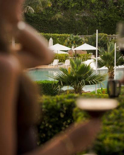 A photo of a cocktail looking towards Castle Harbour pool